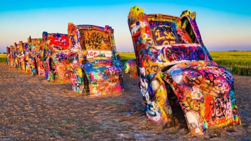 Brightly painted Cadillacs, buried nose-down at Cadillac Ranch, a popular roadside attraction in Texas.