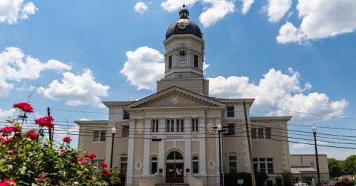 Historic courthouse in Port Gibson, MS, under a bright blue summer sky