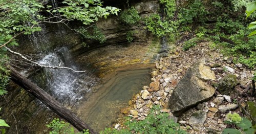 hemmed-in-hollow falls cascading into a pool below in compton arkansas, as seen from above