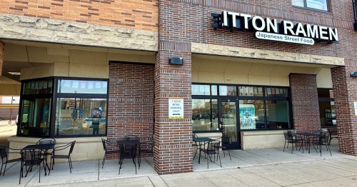 The storefront of Itton Ramen Japanese Street Food in Minnesota showing brick walls and patio seating.