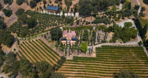 aerial shot of a tuscan-inspired villa airbnb surrounded by gardens in placerville, ca
