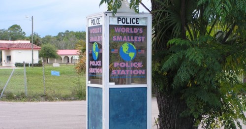 World's Smallest Police Station, which is a phone booth on a roadside in Florida