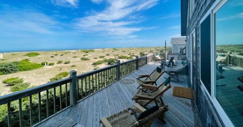 The porch of an Airbnb in Salvo, North Carolina looking toward the dunes and the ocean.