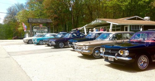 exterior of shady acres with classic cars parked in the parking lot