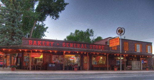 Historic storefront with neon “Bakery – General Store” sign in downtown Torrey.
