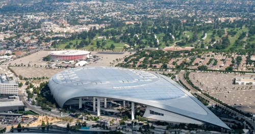 aerial shot of so-fi stadium in inglewood california with los angeles in the background