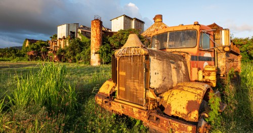 An old vehicle sits in front of the Sugar Mill Plantation on the island of Kauai, Hawaii.