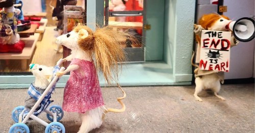 Miniature taxidermy mouse holding an "End is Near" sign next to a mouse pushing a tiny stroller.