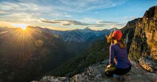 A hiker watches the sunset over the Bitteroot Mountains from Bear Creek Overlook.