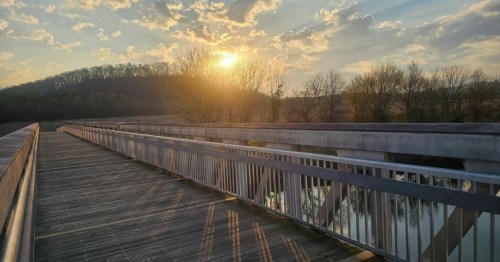 A sunset view from a bridge over the water at Seven Islands State Birding Park in Tennessee.