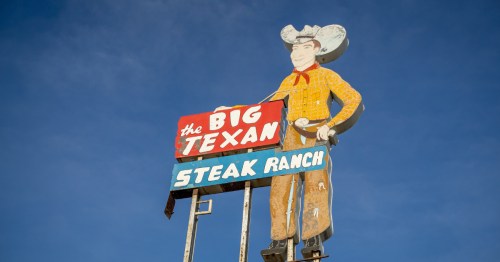 The Big Texan Steak Ranch Light Up Sign With Big Tex Mascot Along Road in Amarillo, Texas