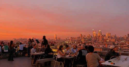 Vibrant pink and orange sunset over the Philadelphia, Pennsylvania skyline from the rooftop at Bok Bar.