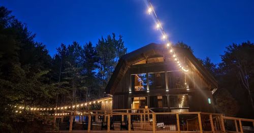 Night time photo of "The Hideaway" Luxury Forest Resort in Hammondsport, New York.