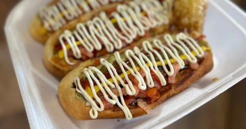 Three perfect Sonoran hotdogs from Tacos Y Hotdogs Los Mayitos in Mesa, Arizona, sit in a white styrofoam container, ready to eat.