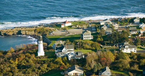 An aerial view of Two Lights State Park in Cape Elizabeth, Maine features a lighthouse and ocean views.