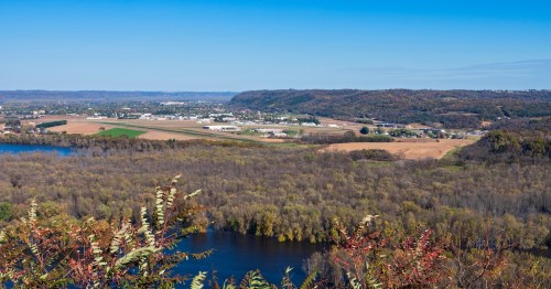 Aerial panorama of Prairie du Chien, WI, showing the Mississippi River valley and distant bluffs.