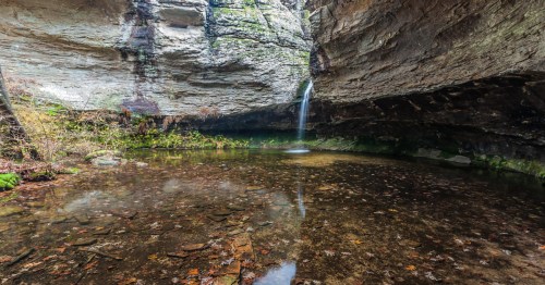 a waterfall in the grotto of petit jean state park in arkansas