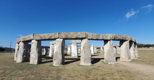 Landscape view of Stonehenge II in Ingram, Texas, under a blue sky.