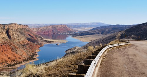Winding roadside view overlooking Flaming Gorge Reservoir and canyon terrain in Manila, Utah.