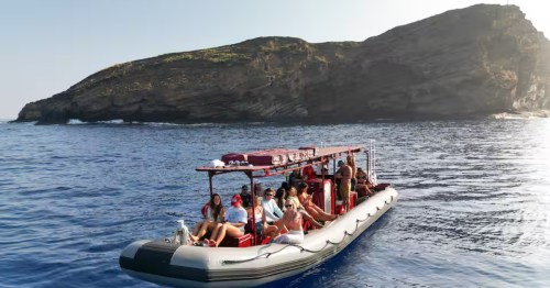 Tour boat with passengers at Molokini Crater Snorkel Trip on Maui, Hawaii.