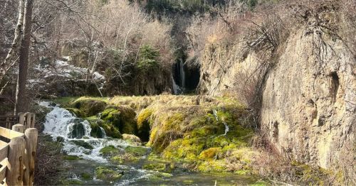 A waterfall next to a trail in South Dakota