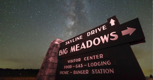 Sign for Big Meadows along Skyline Drive with the night sky and Milky Way overhead