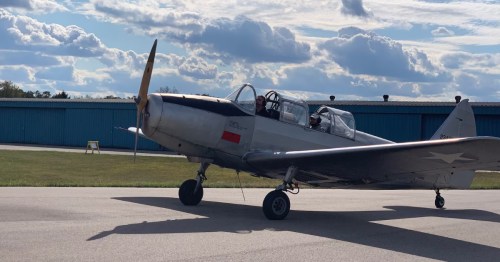 Classic silver WWII warbird taxiing on the runway for a flight demonstration in Middletown OH.