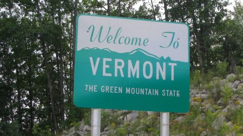 Welcome sign for Vermont, featuring the text "The Green Mountain State" and a mountain graphic in the background.