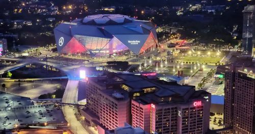 Nighttime aerial view of Mercedes-Benz Stadium in Atlanta, Georgia