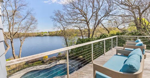A view of the pool and lake from the porch of the Lake House in the City Airbnb property in Arlington, MA.