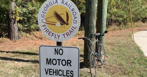 Firefly Trail logo with a bike in the background in Georgia