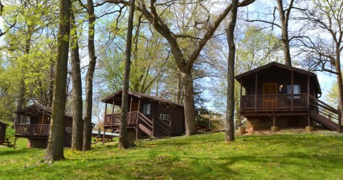 A group of camping cabins tucked between trees at the Hersheypark Camping Resort in Hershey, Pennsylvania.