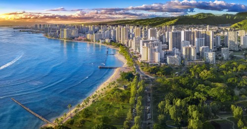 Honolulu skyline at sunset with ocean front.