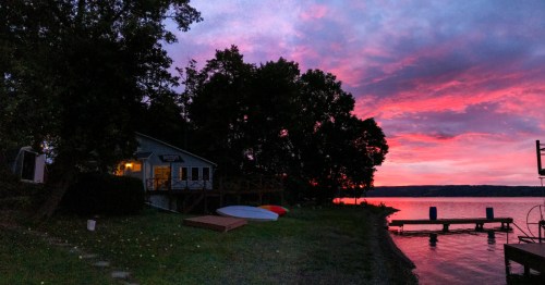 A view of a vacation home on the banks of Keuka Lake in Hammondsport, New York at sunset.