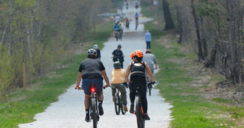 Bikers pedal along the New Hampshire Seacoast Greenway Rail Trail near Portsmouth, NH.