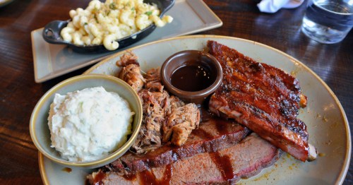 A platter of BBQ from Q39 in Kansas City. Sides of mac and cheese and potato salad accompany.