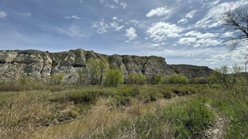 Rock formations sticking out above a prairie.