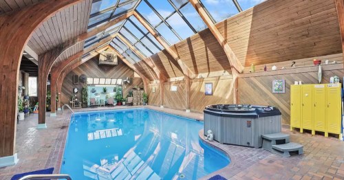 Luxury indoor pool sanctuary with wood finishes and ceiling windows in northern Illinois.