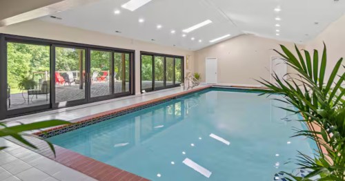 A bright and airy indoor swimming pool at a vacation home in Indiana.