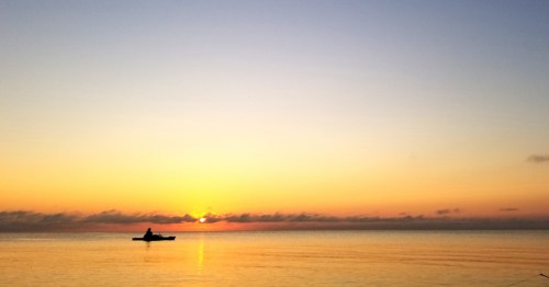 A man fishing at dawn in Lake Michigan in Waukegan, Illinois
