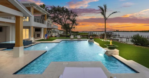 Infinity-edge waterfront pool during sunset at a luxury Airbnb in Florida