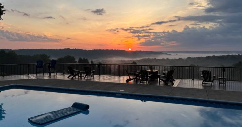 An Airbnb in Pennsylvania with an infinity pool at sunrise.