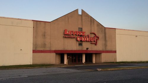 Exterior of a Levitz furniture outlet building, featuring a large sign and a simple, modern architectural design.