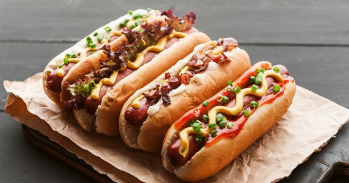 Barbecue Grilled Hot Dogs with yellow American mustard, On a dark wooden background