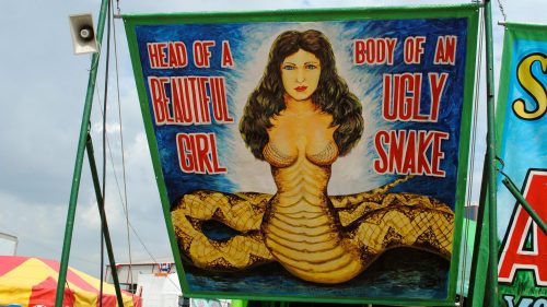 A colorful banner depicting a woman’s head on a snake's body, with the text "Head of a Beautiful Girl, Body of an Ugly Snake."