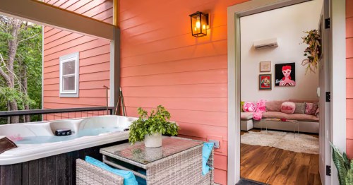 The hot tub on the porch at the pink Barbie Palace AIrbnb property in Black Mountain, North Carolina.