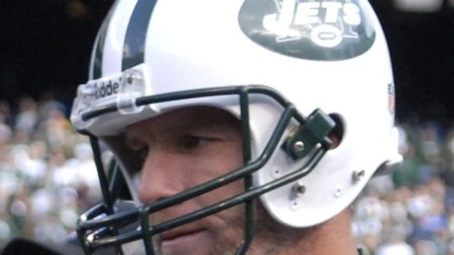 A football player wearing a New York Jets helmet, looking focused on the field during a game.