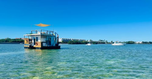 A floating tiny home on the bright blue water in Key West, Florida.