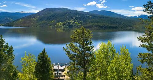 A boathouse overlooks a Colorado lake on a summer day.