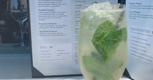 A Hugo Spritz in front of an open menu at Carbonara in Arlington, VA